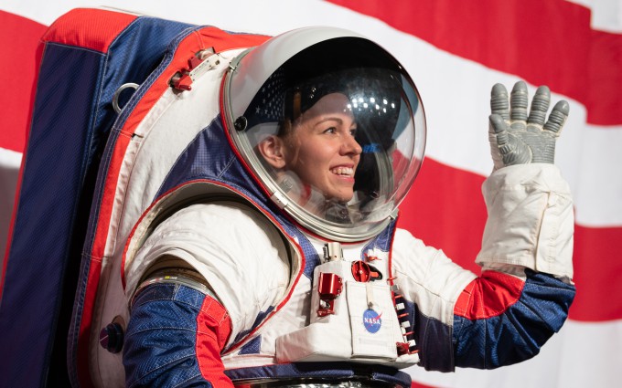 Spacesuit development engineer Christine Davis, a researcher at NASA's Johnson Space Center, shows off a new spacesuit design during the 2019 spacesuit unveiling.  Courtesy of NASA