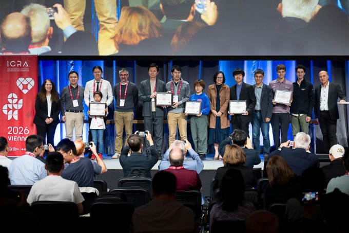From the left, ninth is Dr. Namgyun Kim from KAIST’s Department of Civil and Environmental Engineering and tenth is Professor Ji Hwan Ryu, posing for a commemorative photo after receiving the RA-L Best Paper Award at the ‘2026 IEEE International Conference on Robotics and Automation (ICRA 2026)’ held in Vienna, Austria, on the 1st. Provided by KAIST